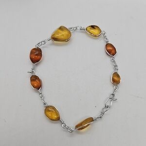 silver tone bracelet with amber colored stations